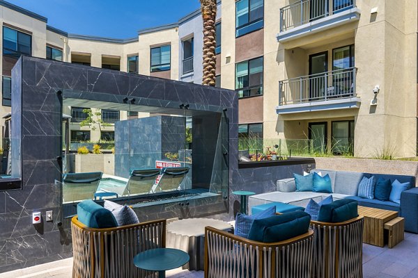 The Lofts at Carlsbad Village: Modern patio with comfortable seating in luxury apartment community