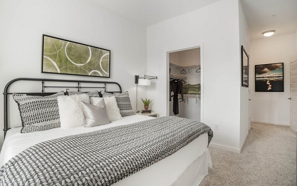 Cozy bedroom with modern furnishings at Metro Mission Valley Apartments offering luxury living