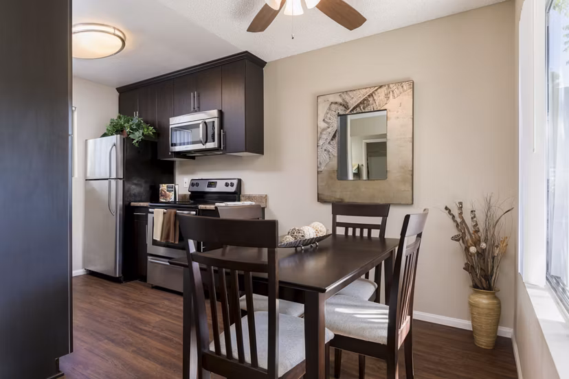 Dining area with modern decor at Navajo Bluffs Apartments featuring elegant lighting and seating