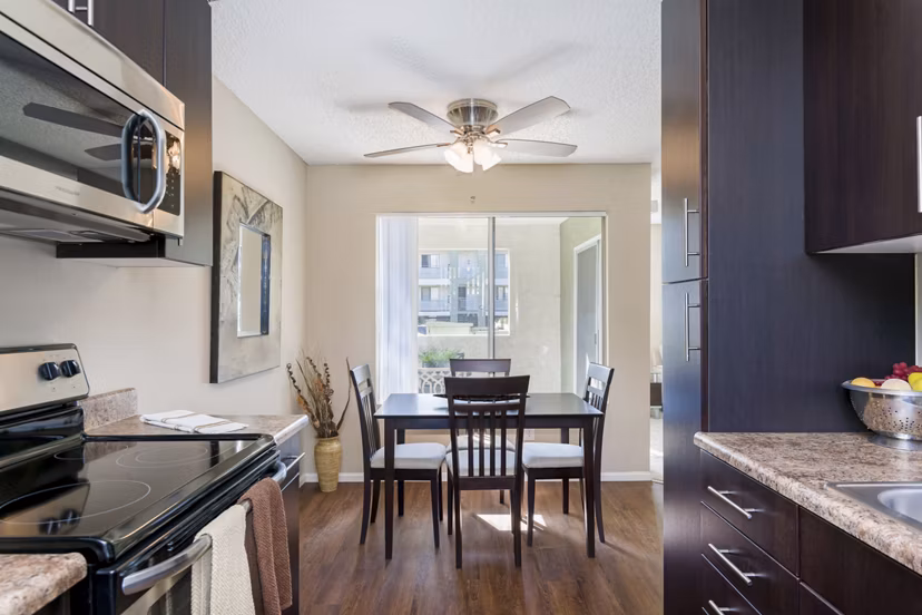 Dining area with modern furnishings at Navajo Bluffs Apartments featuring stylish table settings and natural lighting