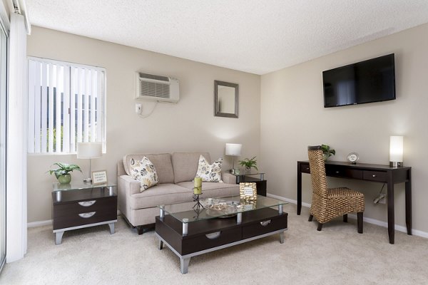 Spacious living room with modern furnishings in Navajo Bluffs Apartments