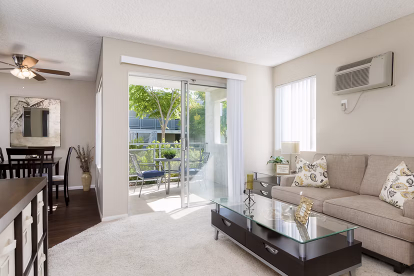 Contemporary living room with cozy seating and natural light at Navajo Bluffs Apartments