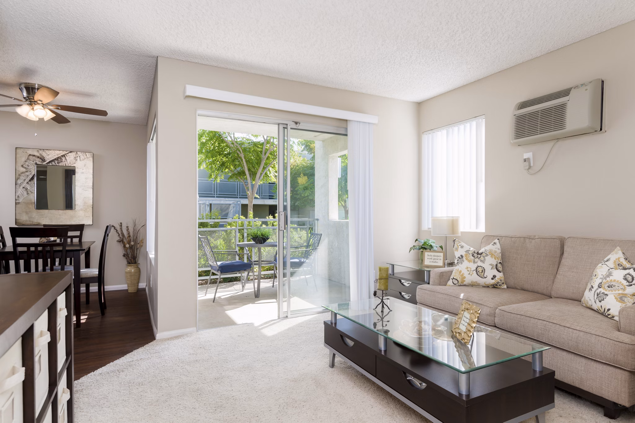Contemporary living room with cozy seating and natural light at Navajo Bluffs Apartments