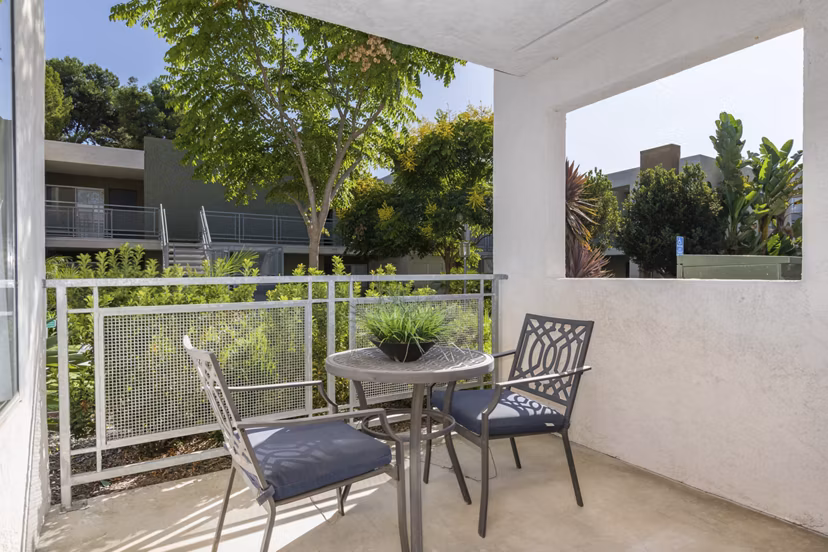 Cozy patio at Navajo Bluffs Apartments featuring lush greenery and comfortable seating for relaxation outdoors