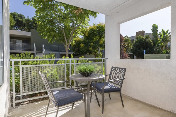 Cozy patio at Navajo Bluffs Apartments featuring lush greenery and comfortable seating for relaxation outdoors