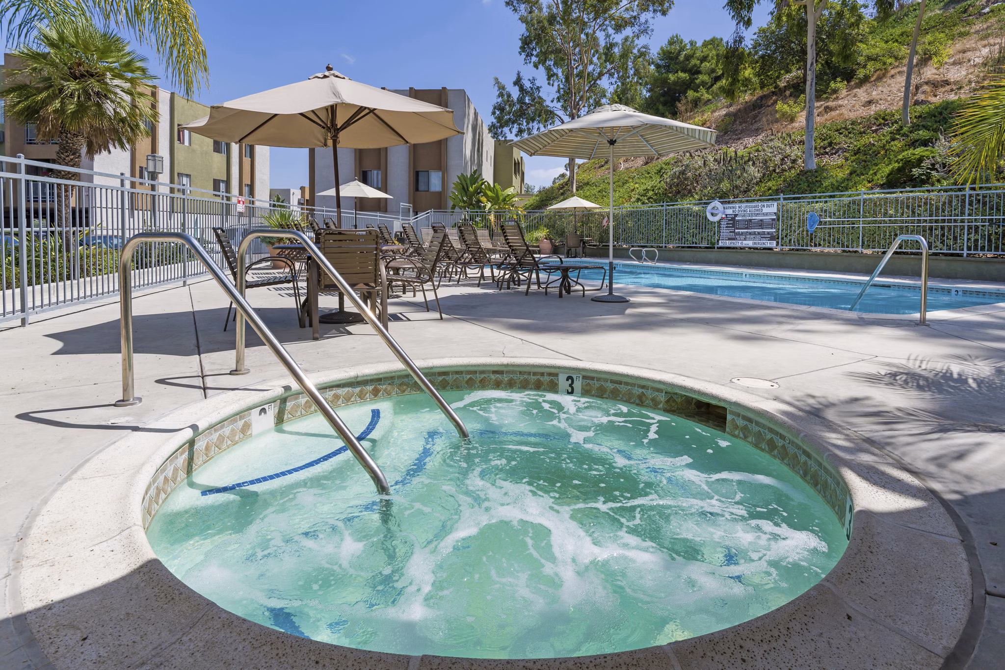 Relaxing hot tub at Navajo Bluffs Apartments with scenic views, offering a luxury amenity for residents seeking leisure and comfort