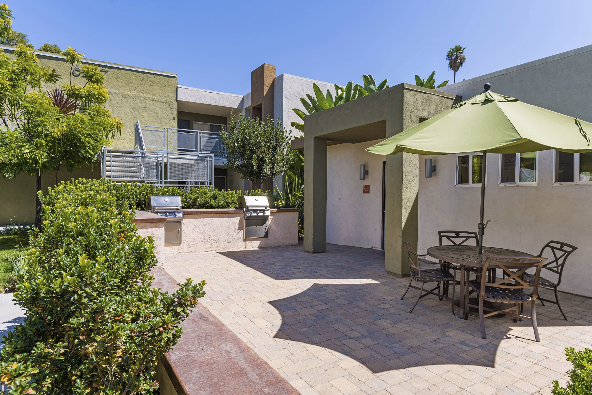 Grill area with modern seating and barbecue stations at Navajo Bluffs Apartments
