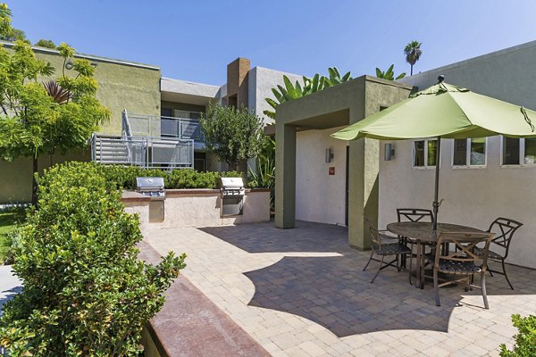Grill area with modern seating and barbecue stations at Navajo Bluffs Apartments