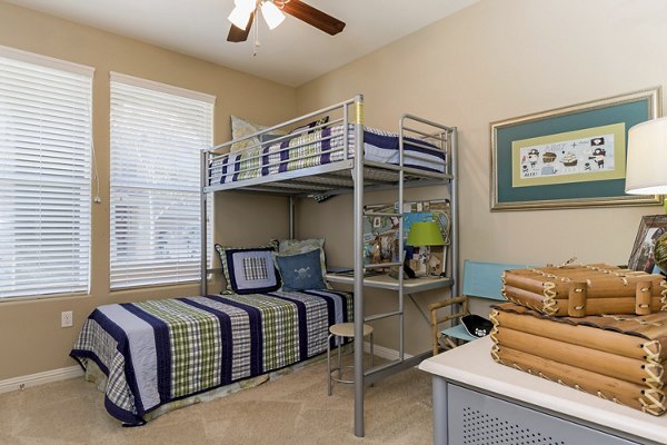 Cozy bedroom with stylish decor at Riveredge Terrace Apartments featuring luxury living by Greystar