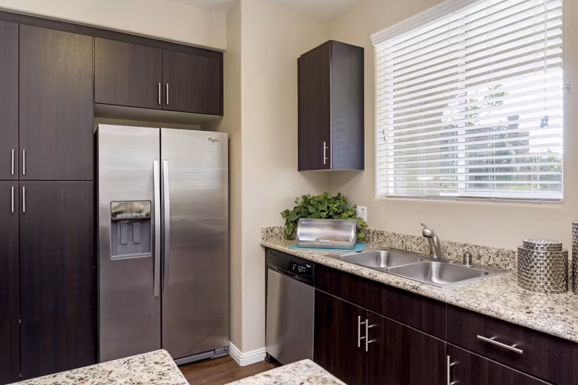Kitchens featuring modern appliances at Riveredge Terrace Apartments in Greystar community