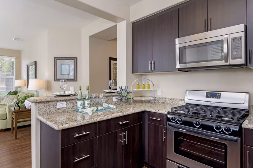 Modern kitchen with stainless steel appliances at Riveredge Terrace Apartments