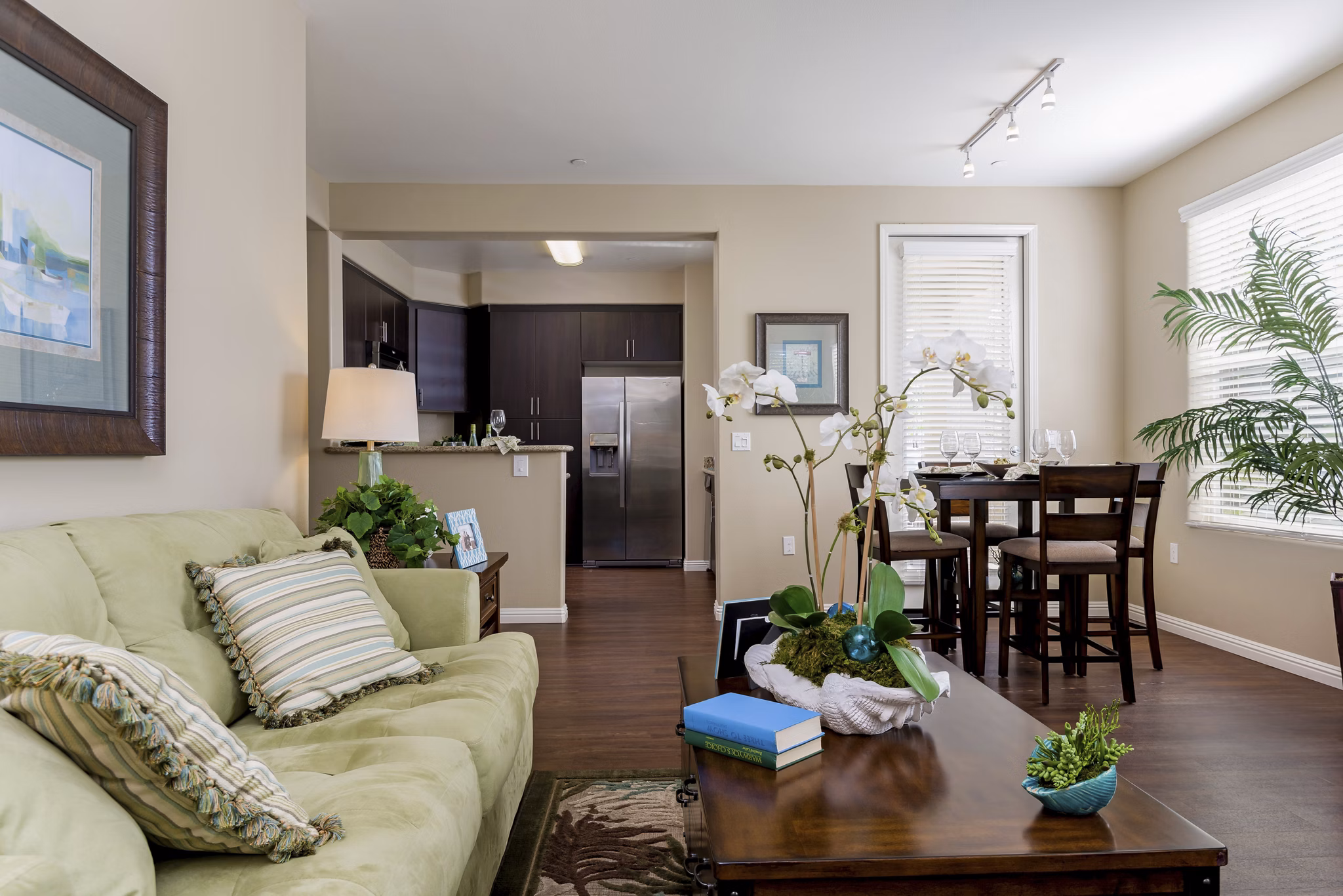 Spacious living room with modern decor at Riveredge Terrace Apartments, featuring cozy seating and large windows