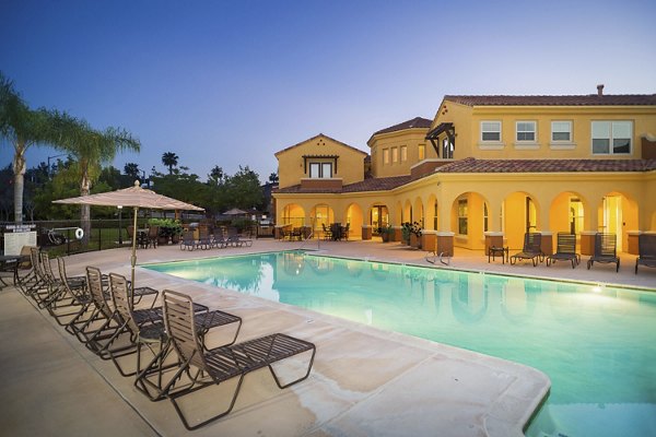 Luxury pool with sun loungers at Riveredge Terrace Apartments, offering relaxation and recreation for residents