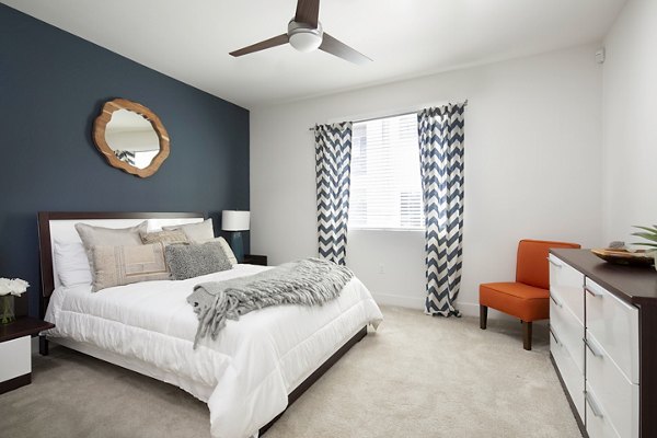 Bedroom featuring modern decor and ample natural light at Palomar Station Apartments