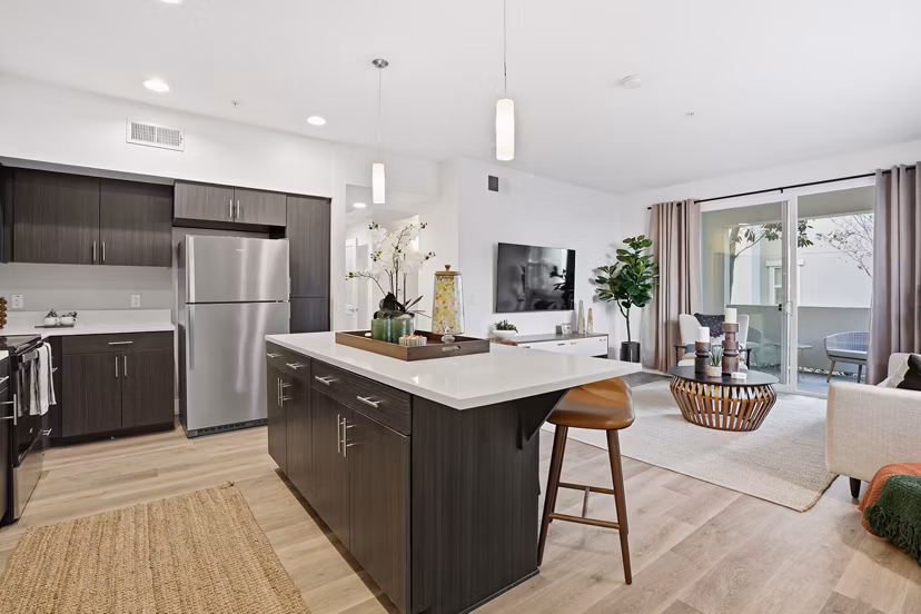 Modern kitchen with stainless steel appliances at Palomar Station Apartments