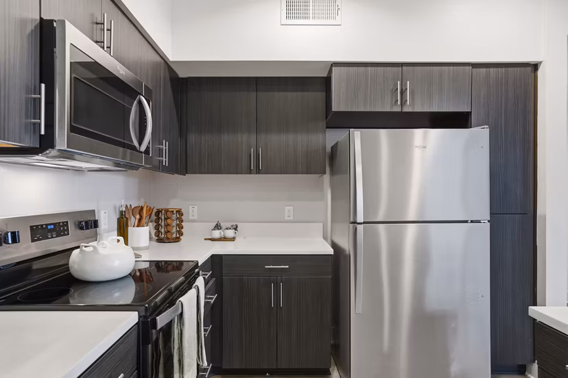 Modern kitchen with sleek countertops and stainless steel appliances at Palomar Station Apartments