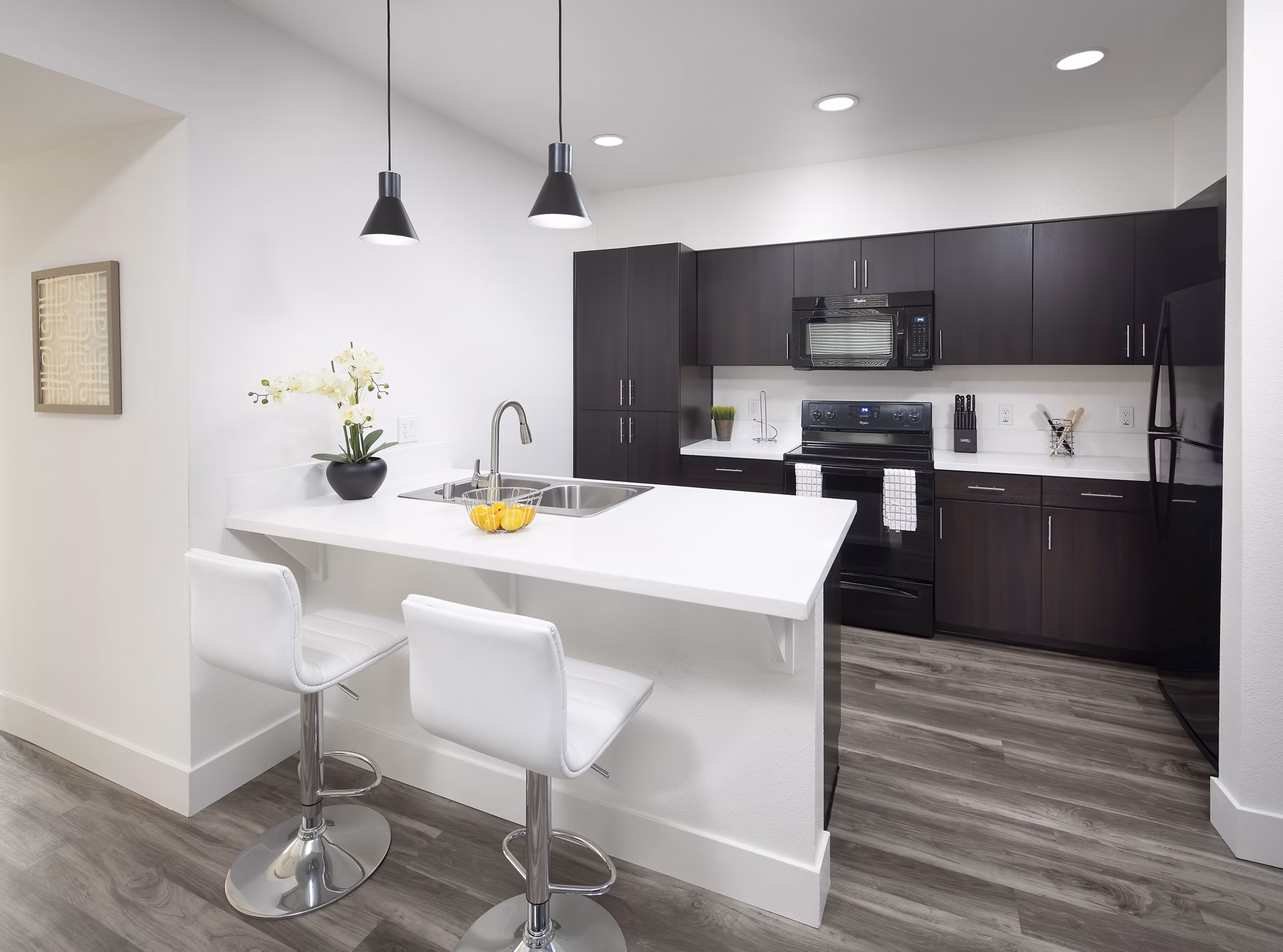 Modern kitchen with sleek countertops and stainless steel appliances at Palomar Station Apartments
