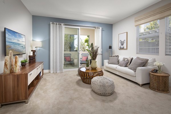 Spacious living room with modern furniture and large windows at Palomar Station Apartments, Greystar luxury apartments in San Marcos