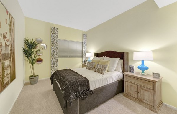 Modern bedroom with plush carpeting and large windows in Parc One Apartments