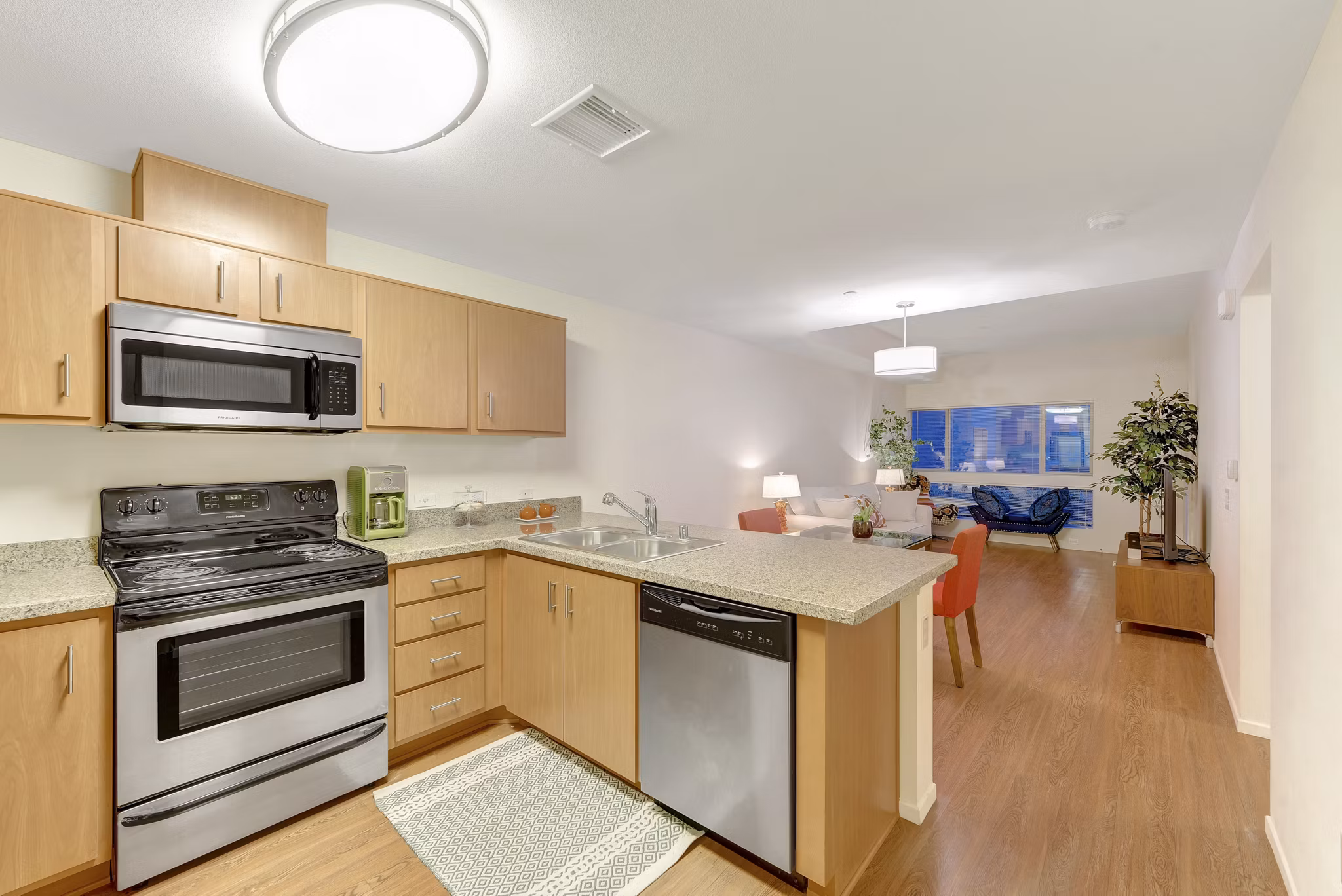 Modern kitchen with sleek appliances and granite countertops at Parc One Apartments, a Greystar luxury community