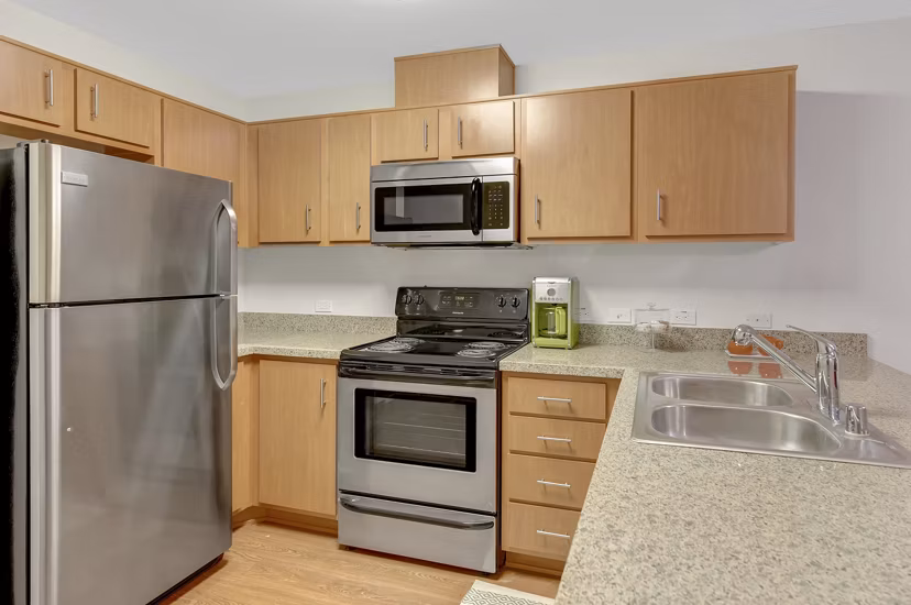 Modern kitchen featuring stainless steel appliances and granite countertops at Parc One Apartments