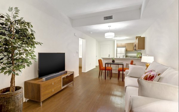 Living room featuring modern decor and large windows at Parc One Apartments