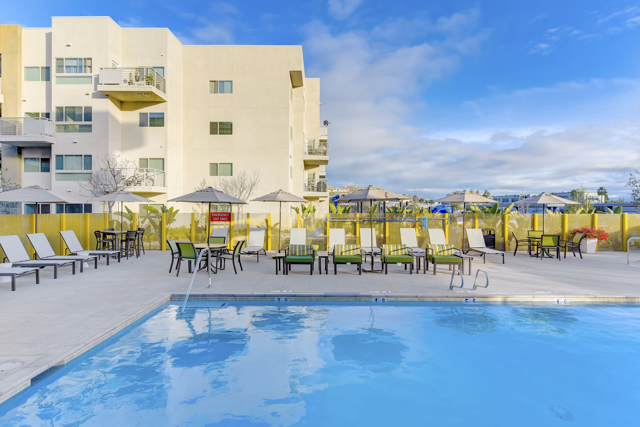 Luxurious pool area with loungers at Parc One Apartments