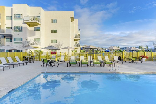 Luxurious pool area with loungers at Parc One Apartments