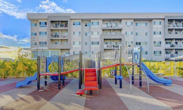 Colorful playground with modern equipment at Parc One Apartments, offering family-friendly outdoor activities for residents of all ages