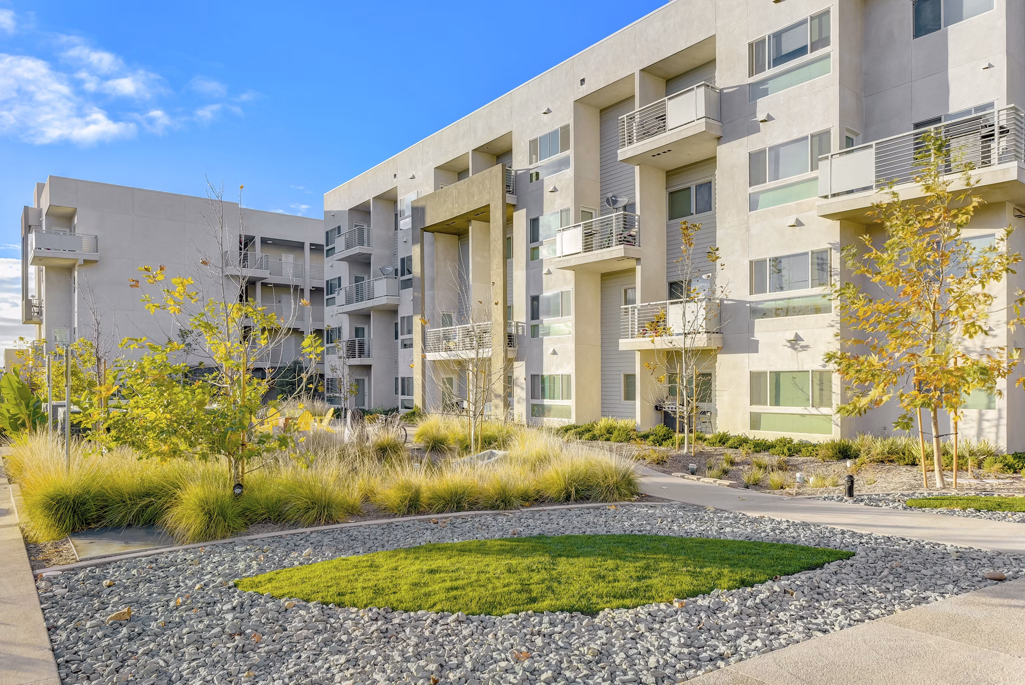 Parc One Apartments: Lush courtyard with greenery and seating areas