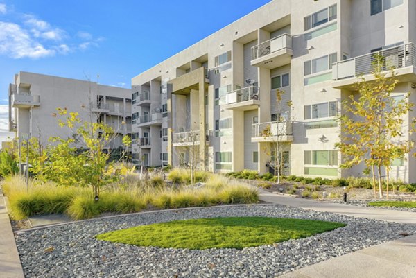 Parc One Apartments: Lush courtyard with greenery and seating areas