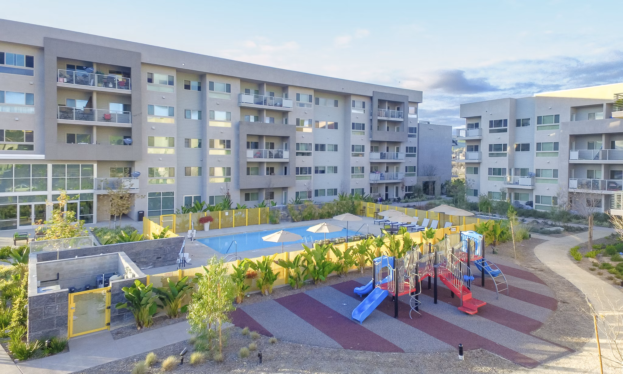 Scenic sunset view from Parc One Apartments' balcony overlooking lush gardens
