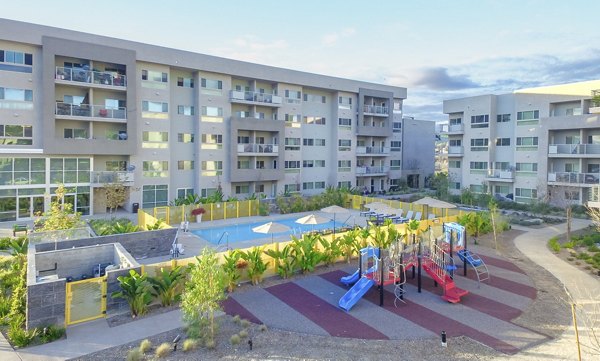 Scenic sunset view from Parc One Apartments' balcony overlooking lush gardens