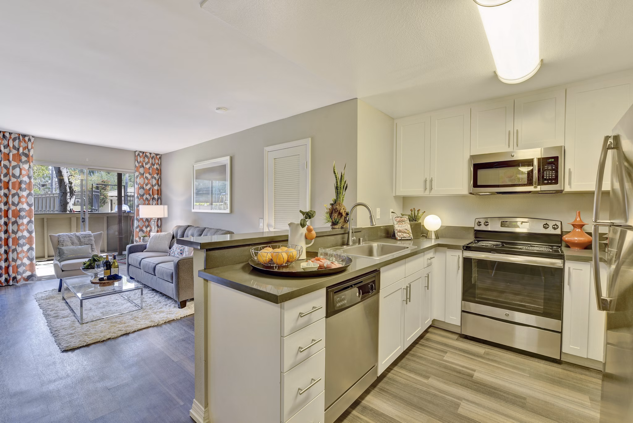 Park Pointe Apartments: Modern kitchen with stainless steel appliances and granite countertops in luxury Greystar community