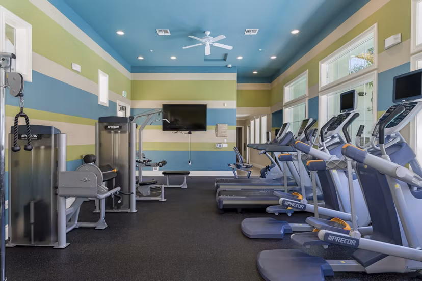 Modern fitness center with state-of-the-art equipment at Rosina Vista Apartments with ample space for workouts and wellness activities