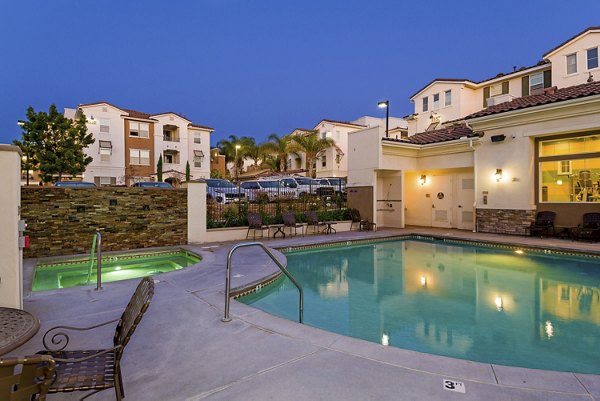Resort-style pool with lounge chairs at Rosina Vista Apartments