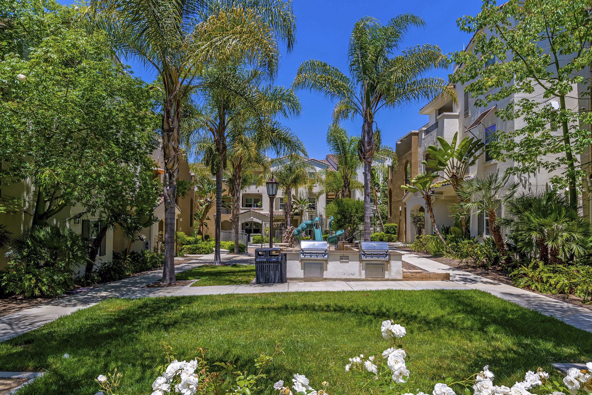 Grill area and courtyard with outdoor seating at Rosina Vista Apartments, a luxury property in Chula Vista, CA
