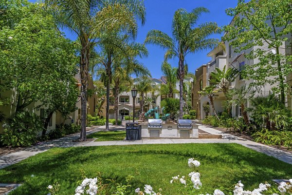 Grill area and courtyard with outdoor seating at Rosina Vista Apartments, a luxury property in Chula Vista, CA