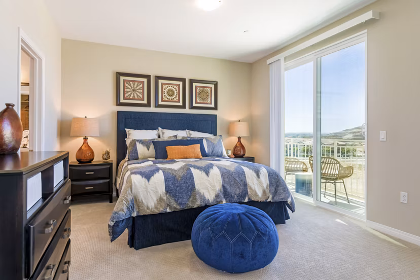 Bedroom with stylish decor and ample natural light in Salerno Apartments, luxury living by Greystar