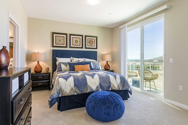 Bedroom with stylish decor and ample natural light in Salerno Apartments, luxury living by Greystar