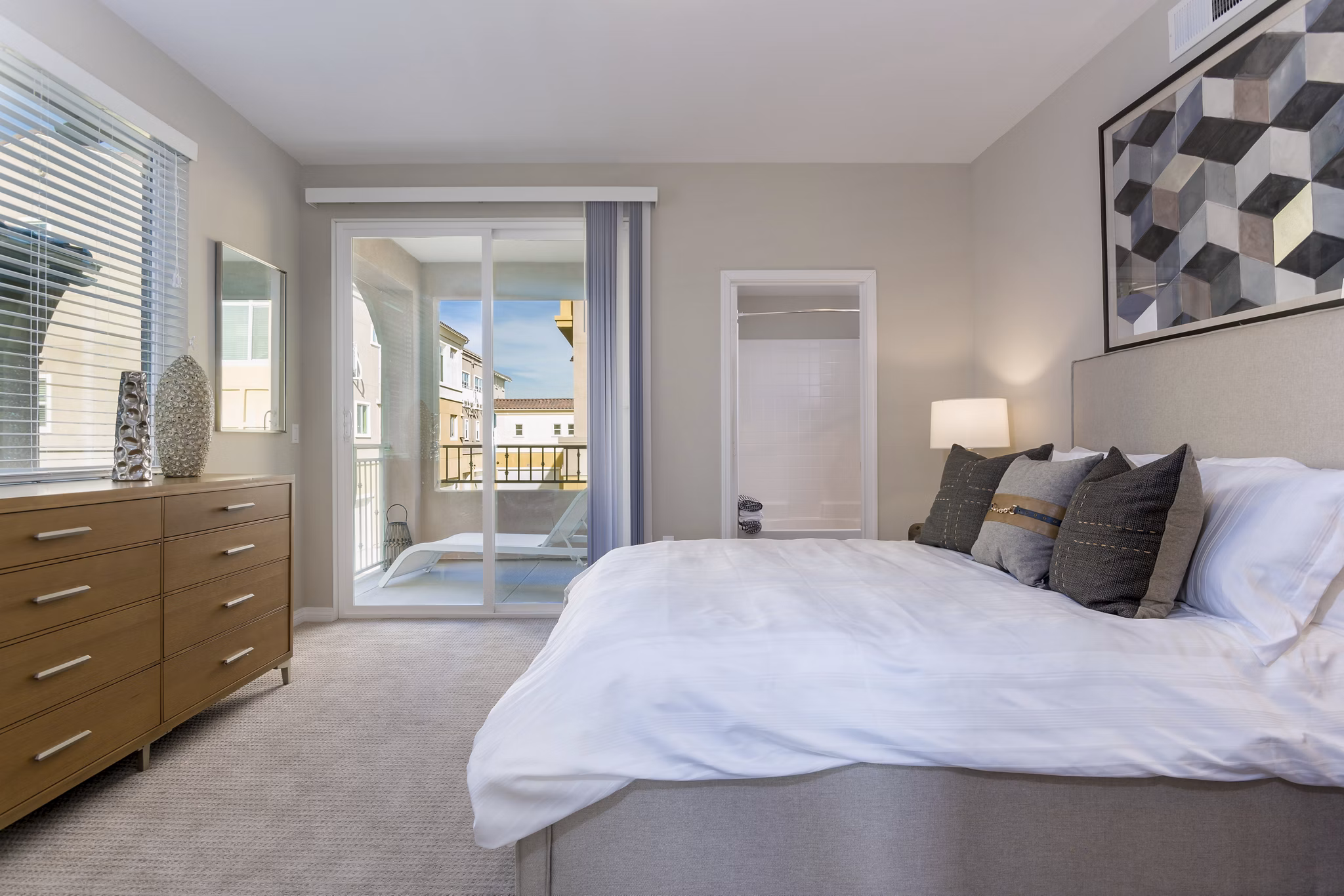 Cozy bedroom with elegant furnishings at Salerno Apartments, Greystar's luxury living spaces