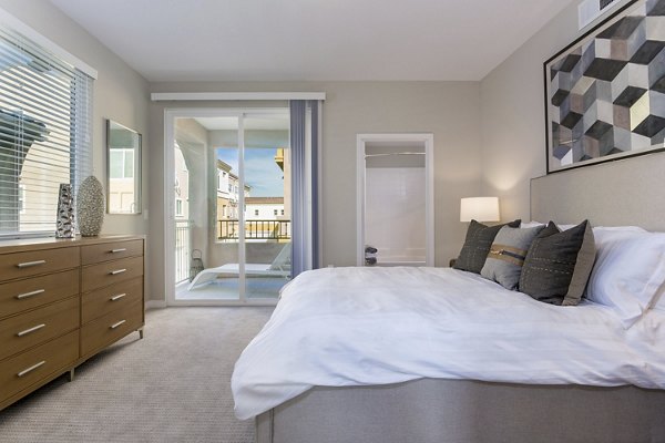 Cozy bedroom with elegant furnishings at Salerno Apartments, Greystar's luxury living spaces