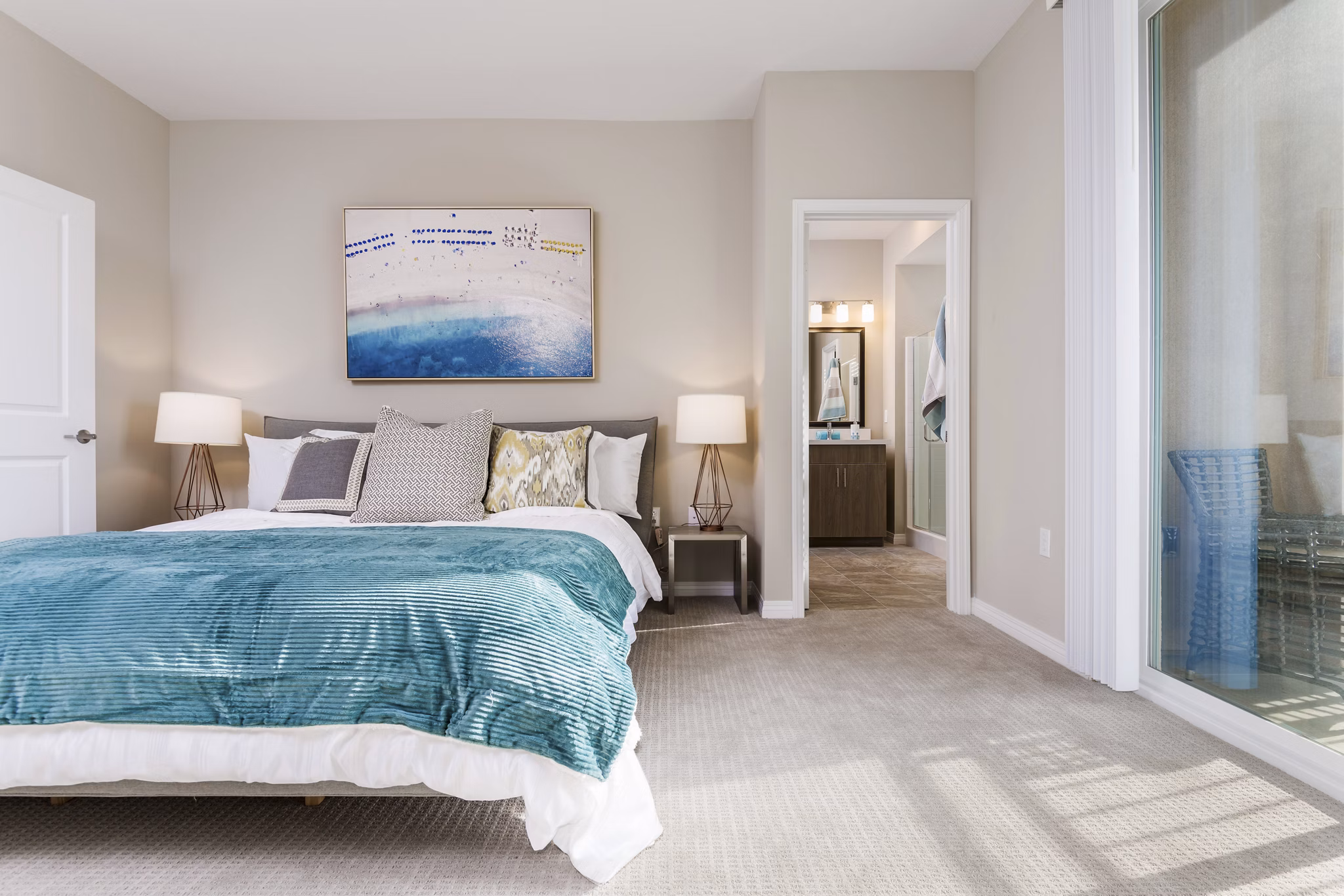 Bedroom with large windows and modern decor at Salerno Apartments