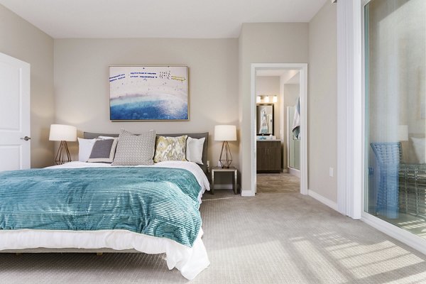 Bedroom with large windows and modern decor at Salerno Apartments