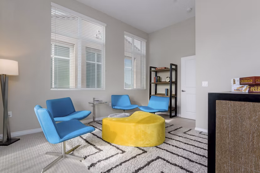Elegant bedroom featuring modern decor and large windows at Salerno Apartments, offering luxury living spaces in vibrant urban environments