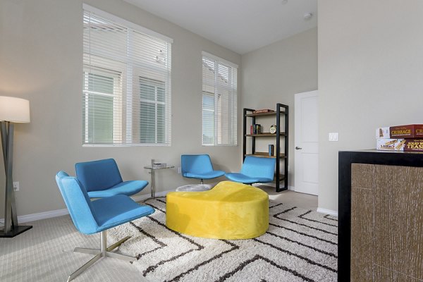 Elegant bedroom featuring modern decor and large windows at Salerno Apartments, offering luxury living spaces in vibrant urban environments