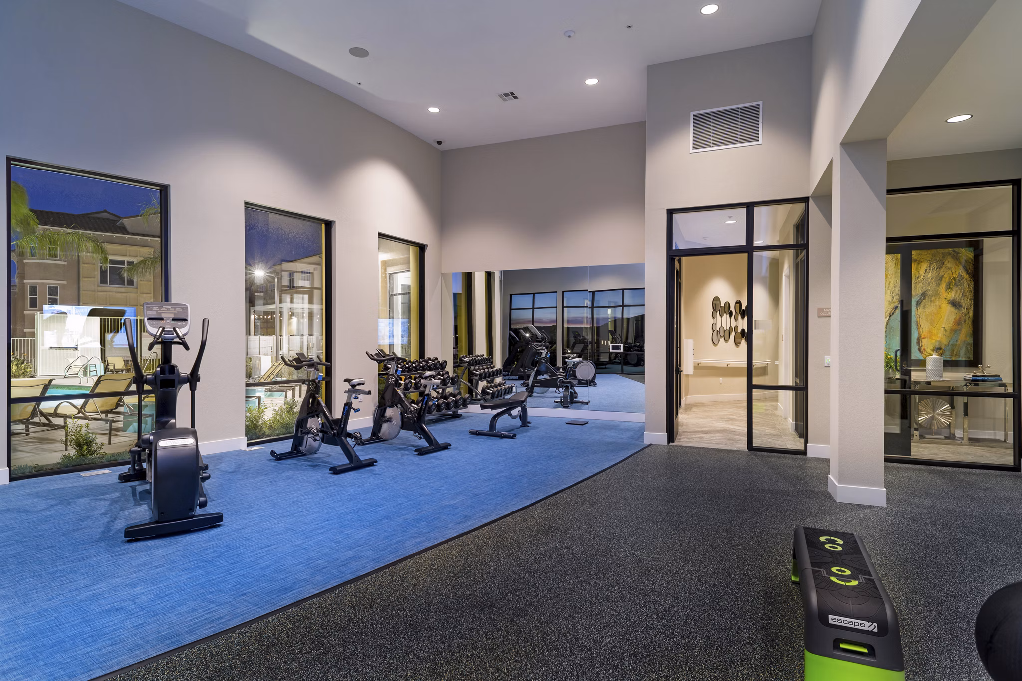 Fitness center equipped with modern exercise machines at Salerno Apartments