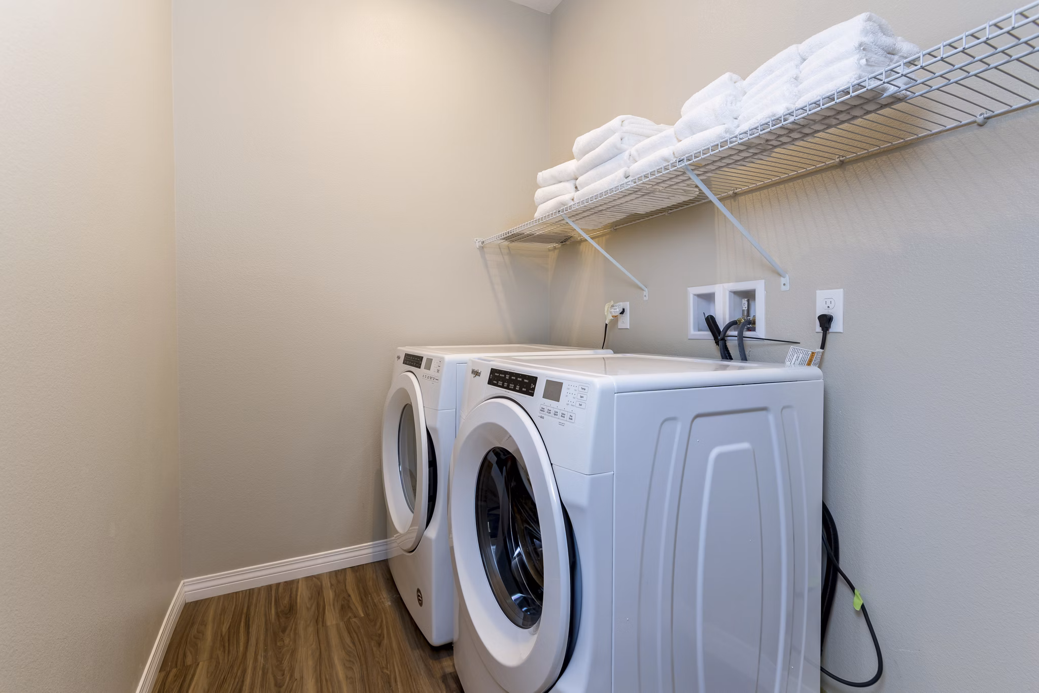 Laundry room featuring modern appliances at Salerno Apartments, luxury living by Greystar in a convenient location