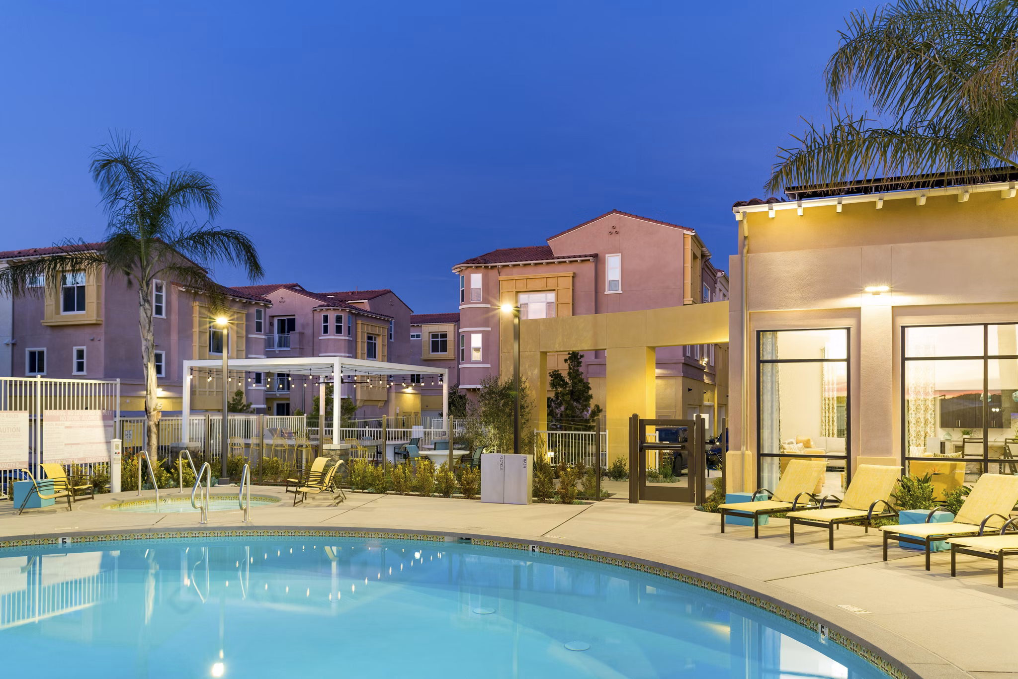 Resort-style pool area with palm trees at Salerno Apartments offering luxury amenities in Miami
