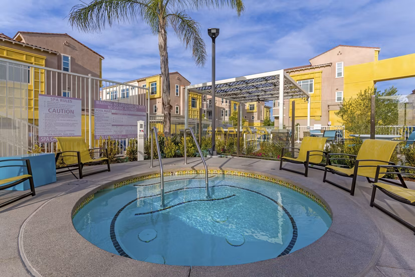 Hot tub at Salerno Apartments: Relaxing outdoor jacuzzi surrounded by lush landscaping Perfect for unwinding after a long day